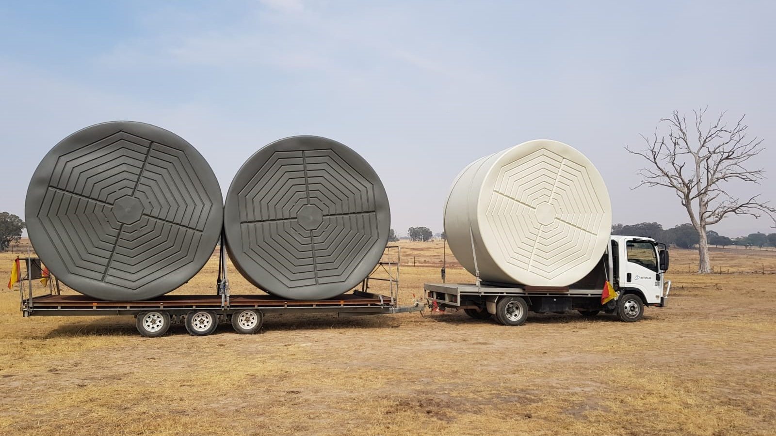 Rural water tanks on a truck in a dry paddock