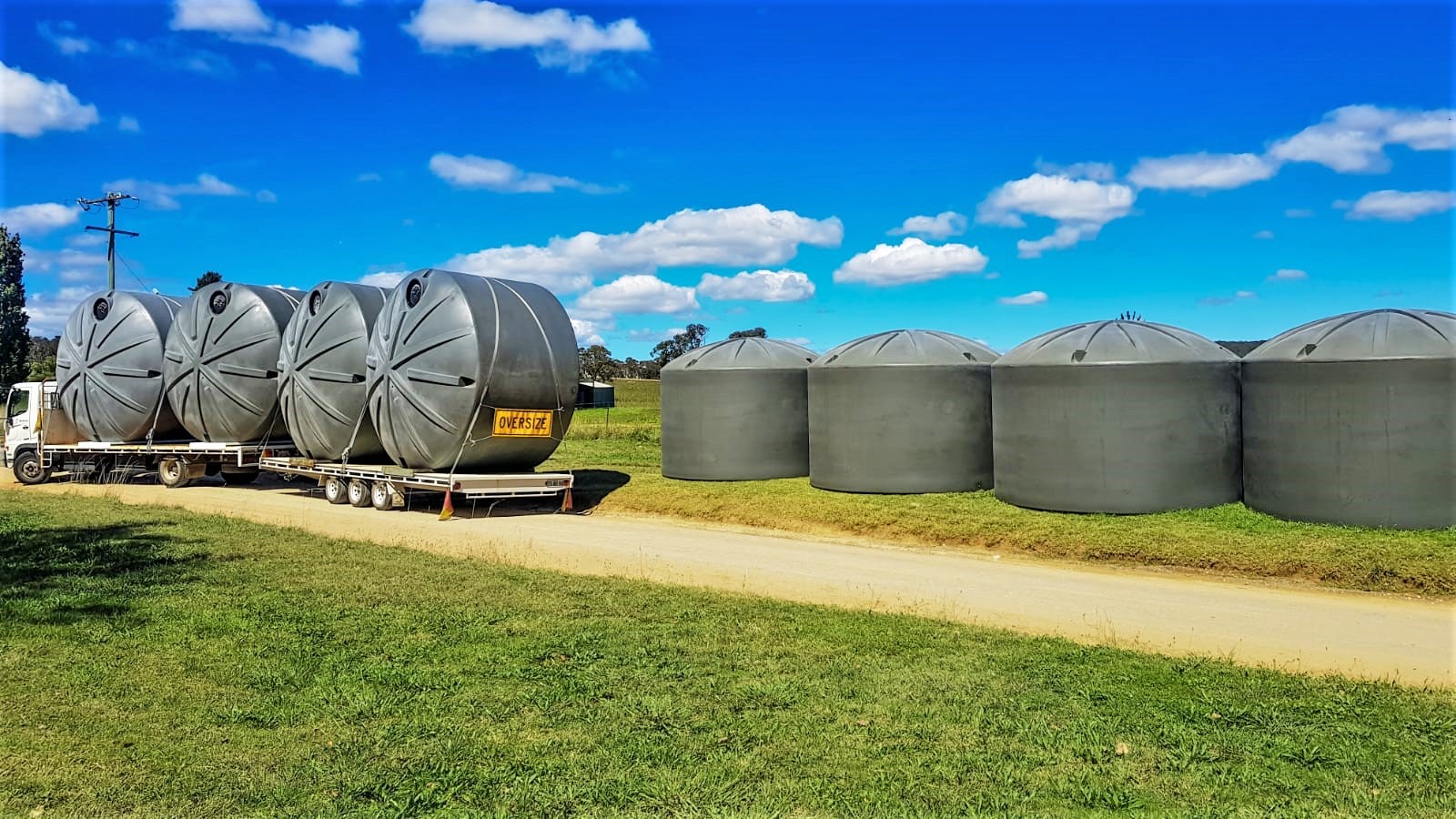 lots of rural water tanks in a paddock